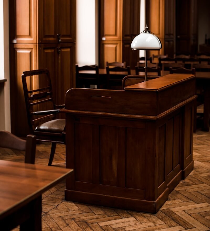 a wooden bar with a lamp on top of it